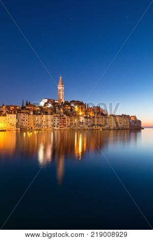 Sunset at medieval town of Rovinj colorful with houses and church in Croatia