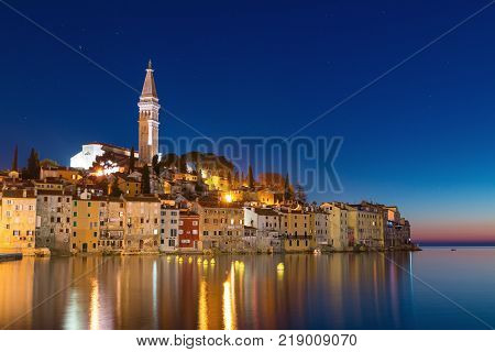 Sunset at medieval town of Rovinj colorful with houses and church in Croatia