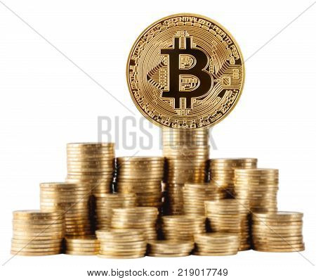 Gold bitcoin on top of the highest stack of coins isolated on white background. The concept of crypto currency development.