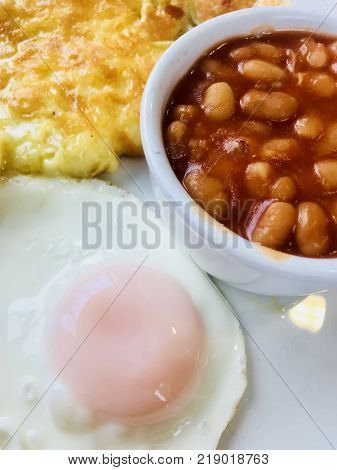 Cheese omelette with fried egg and baked beans
