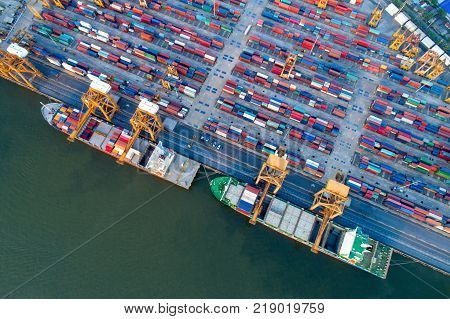 Containers yard in port congestion with ship vessels are loading and discharging operations of the transhipments in international port.