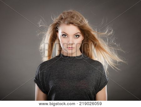 Perfect beauty. Young attractive glamorous female model studio shot. Gorgeous charming blonde woman with make up and waving hair looking seductive.