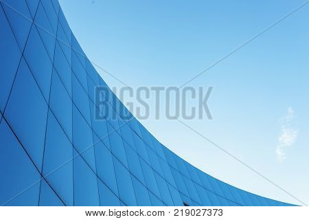 Corporate building on the blue sky background with isolated place for text
