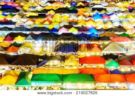 aerial view colorful of plastic roof of tent at ratchada train night market of bangkok city. popular place for shopping at night.