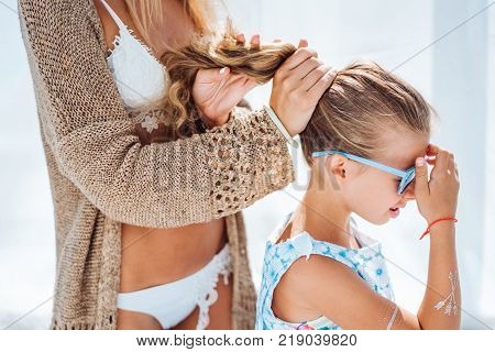 Mom and daughter spend time together on the beach bed