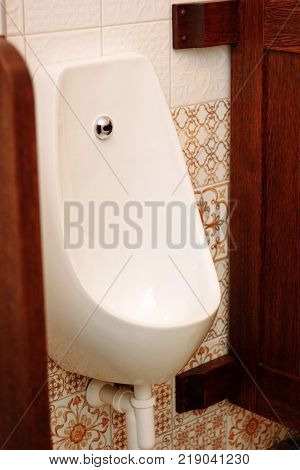 White ceramic pissoir in a classic wc