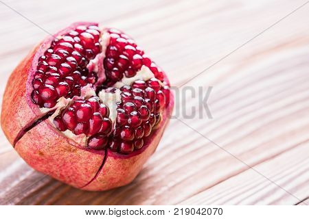 Big red pomegranate on the wooden board. Ripe granet fruit.