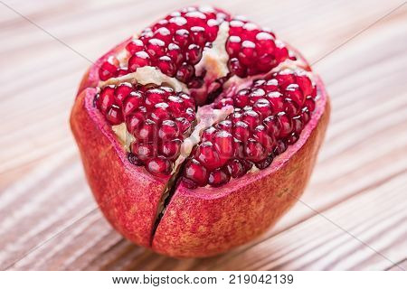 Big red pomegranate on the wooden board. Ripe granet fruit.