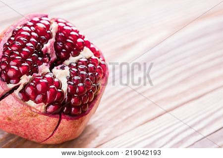 Big red pomegranate on the wooden board. Ripe granet fruit.