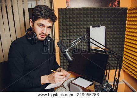 Microphone in radio studio and presenter on background