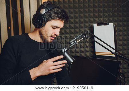 Microphone in radio studio and presenter on background