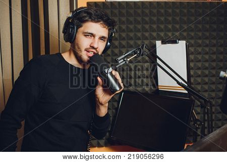 Microphone in radio studio and presenter on background