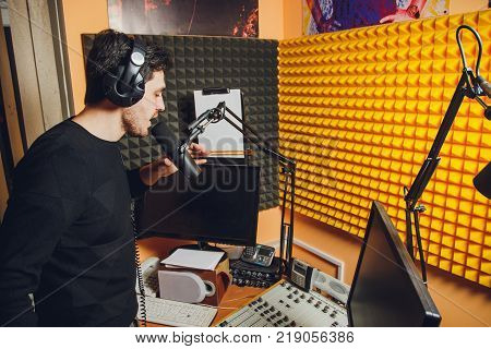 Microphone in radio studio and presenter on background