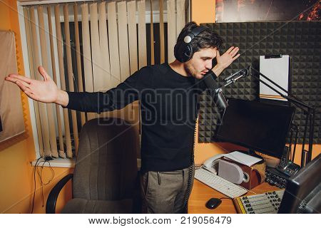 Microphone in radio studio and presenter on background