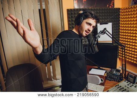 Microphone in radio studio and presenter on background