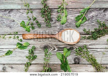 sesame seeds in a wooden spoon on rustic background. healthy diet. Top view
