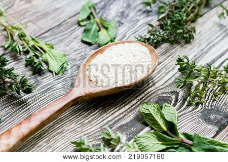 sesame seeds in a wooden spoon on rustic background. healthy diet. Top view