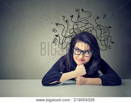 Business woman wearing glasses thinking contemplating a solution