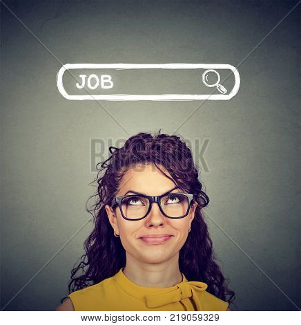 Smart woman in eyeglasses looking up on search bar with word Job looking excited.