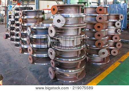 Heap of valve bodies spare parts prapared for mashining in factory. Casting carbon steel boides. Forging stainless still parts. Industrial background from part of valves for power oil or gas industry