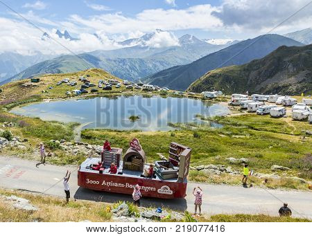 Col de la Croix de Fer France - 25 July 2015: Banette caravan driving on the road to the Col de la Croix de Fer in Alps during the stage 20 of Le Tour de France 2015. Banette is the leading brand for the artisan bread in France.