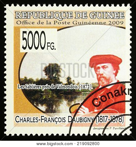 Moscow Russia - December 19 2017: A stamp printed in Guinea shows French artist Charles-Francois Daubigny (1817-1878) and his picture 