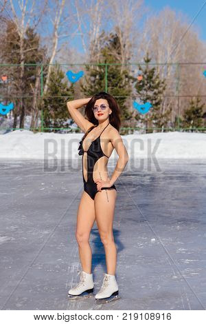 Novokuznetsk, Kemerovo region, Russia - 23 Feb, 2017 : White beaches of Siberia is an enterteiment activity where people playing beach games dressed in bikini in winter. Woman in bikini on ice skates