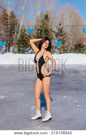 Novokuznetsk, Kemerovo region, Russia - 23 Feb, 2017 : White beaches of Siberia is an enterteiment activity where people playing beach games dressed in bikini in winter. Woman in bikini on ice skates