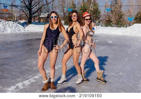Novokuznetsk, Kemerovo region, Russia - 23 Feb, 2017 : White beaches of Siberia is an enterteiment activity where people playing beach games dressed in bikini in winter. Women in bikini on ice skates