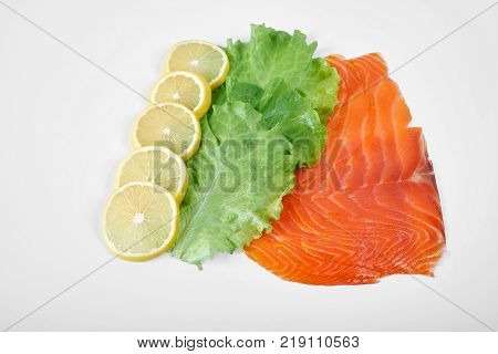 Smoked Fillet salmon with lemon and salad isolated on white background.
