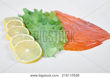 Smoked Fillet salmon with lemon and salad isolated on white background.