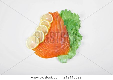 Smoked Fillet salmon with lemon and salad isolated on white background.