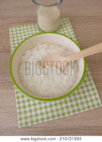 Congee with rice in bowl and glass of rice