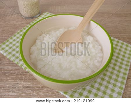Congee with rice in bowl and glass of rice