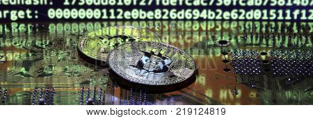 The digital process of cryptocurrency mining by using the GPUs. Bitcoins and video card on a working display and mining screen