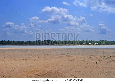 Beautiful summer sky and river divided by horizontal village line