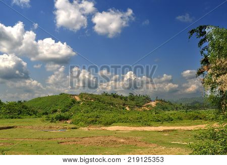 Beautiful summer landscape with low land hilly land and blue sky with fluffy clouds