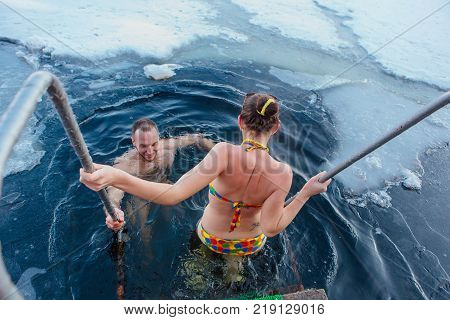 Novokuznetsk, Kemerovo region, Russia - 23 Feb, 2017 : White beaches of Siberia is an enterteiment activity where people playing beach games dressed in bikini in winter. Couple in ice hole