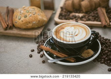 Morning coffeeLatte coffee in cup on tablevintage tone.