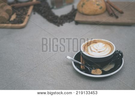 Morning coffeeLatte coffee in cup on tablevintage tone.