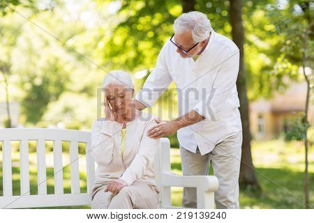 health, stress, old age and people concept - senior woman suffering from headache outdoors
