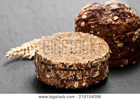 Sliced rye bread on black stone background