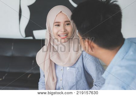 happy young muslim friend laughing together and having a good talk in a coffeshop