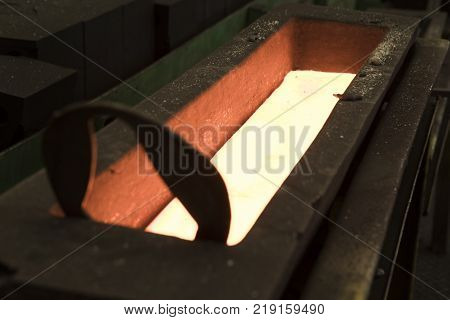Molten metal Iron Casting in metal mold ; close up