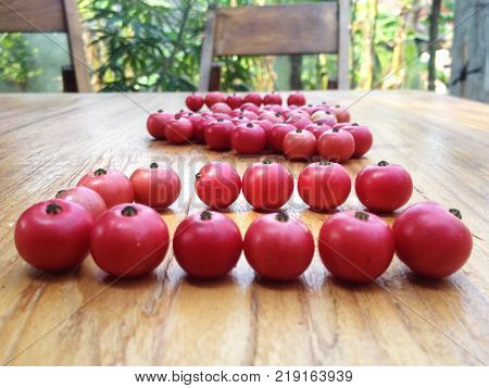 Red calabura friut on table, asian cherry fruit