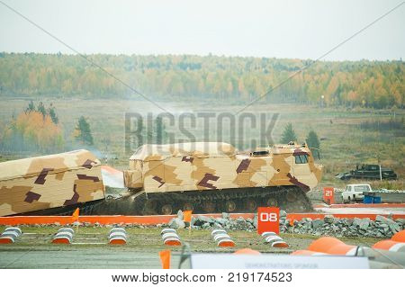 Nizhniy Tagil, Russia - September 25. 2013: Tracked carrier DT-30P1 on demonstration range. It leaves after overcoming of water ford. Russia Arms Expo-2013 exhibition