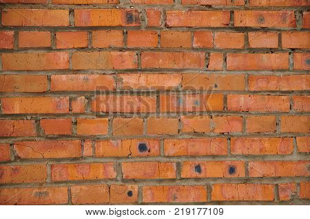 The texture of an old wheatered red brick wall, background