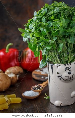 Bazil leaves on kitchen over wooden table