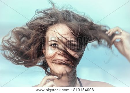 Portrait of beautiful girl with disheveled hair