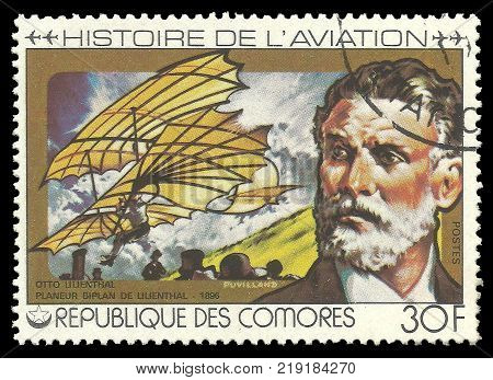 Kiev, Ukraine, December 22, 2017 - CIRCA 1978: stamp printed by Comoros Color memorable offset  Edition on Topic of Aviation History Shows Otto Lilienthal 1896 and airplane